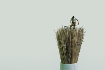 a farmer works with a scythe on a brush