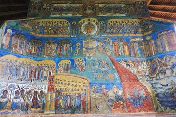 Painted wall at Voronet Monastery in Voronet, Bucovina, Romania. Representation of the Last Judgment Day on the west wall at monastery.