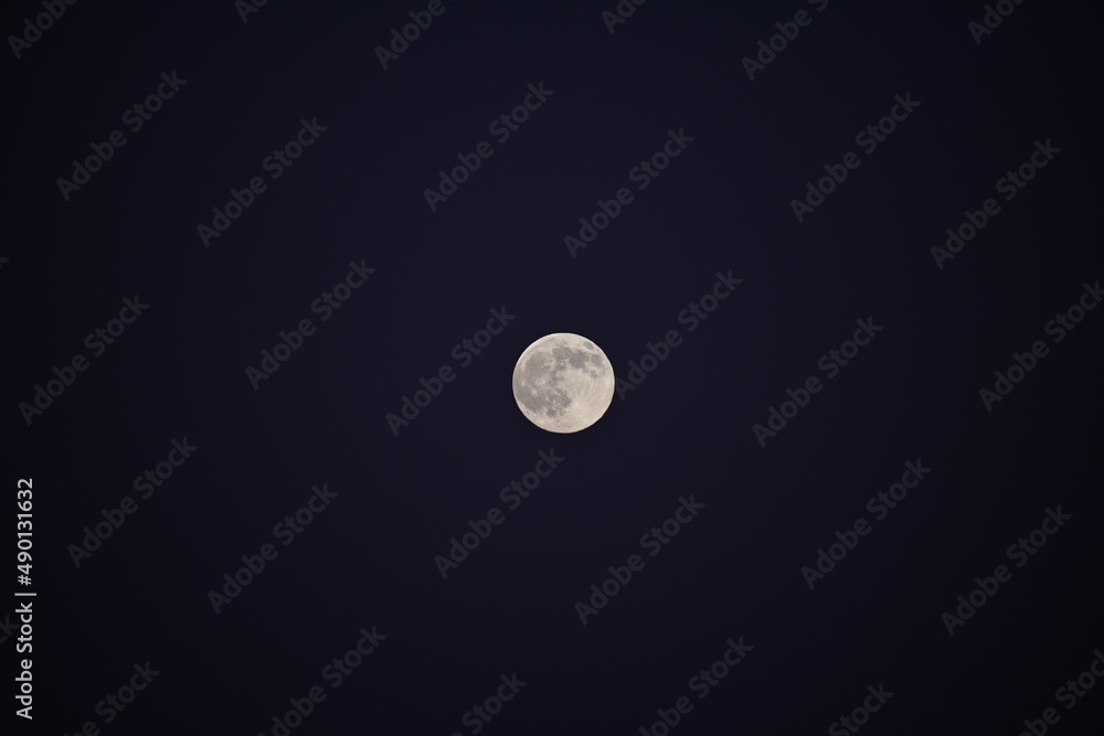 Sticker view of a full moon in the dark night sky