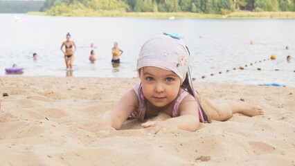  girl playing on the beach on summer holidays. Children building a sandcastle at sea. family, brother and sister are relaxing on the beach. vacation. happy childhood