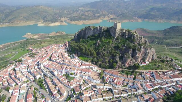 aerial view of medieval Andalusian white village near a blue lake, Iberian landmark and Spanish tourist destination, the village of Zahara de la Sierra