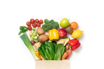 Zelfklevend Fotobehang Healthy food background. Healthy food in paper bag vegetables and fruits on white. Food delivery, shopping food supermarket concept © missmimimina