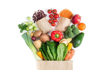 Healthy food background. Healthy food in paper bag vegetables and fruits on white. Food delivery,...