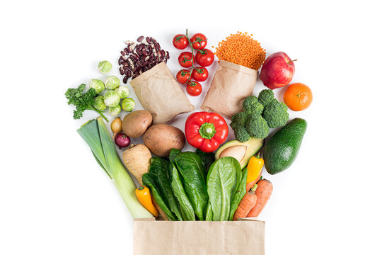 Healthy food background. Healthy food in paper bag vegetables and fruits on white. Food delivery, shopping food supermarket concept. Vegetarian meal
