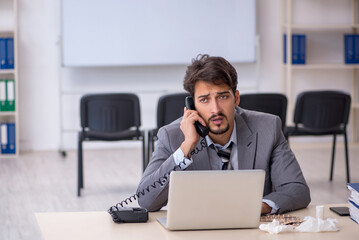 Young businessman employee suffering at workplace