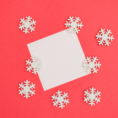 Christmas Square leaflet mock up blank template design idea. White Christmas snowflakes mockup against pastel pink background. Copy space templates designs for new year message layout. Noel.