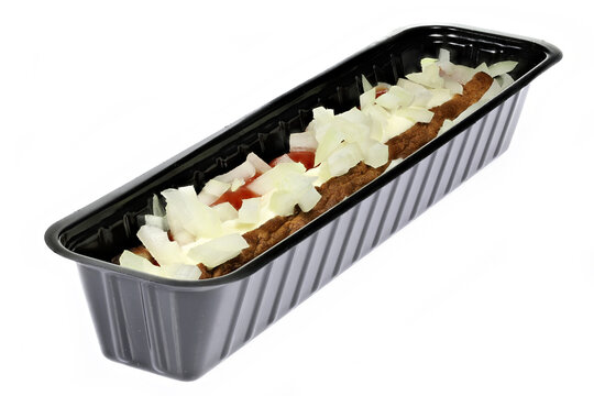 Dutch frikandel speciaal in a black plastic container isolated on white background
