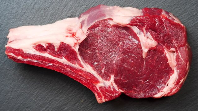 Meat Rotating Background. Raw Beef Entrecote Close Up Video Backdrop. Food Concept. Ready to Grill Meat on the Bone