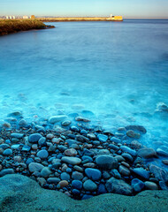 View of Aberdeen harbor from Tory - Details of shore and pebble - slow shutter speed giving milky effect on the sea. © Collpicto