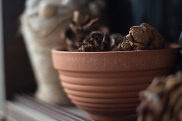Cruse. Things on balcony. Old vase. Item on shelf.