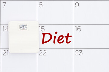 Starting diet date concept on a calendar with a weight scale