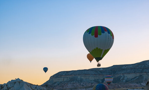 Hot air balloons in Cappadocia sky at sunrise