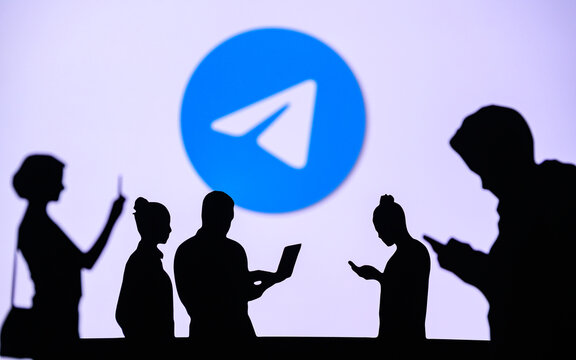 NEW YORK, USA, 1. MARCH 2022: ​​Telegram App, Group Of Business People Chat On Mobile Phone And Laptop. ​​Telegram – Freeware, Cross-platform, Cloud-based Instant Messaging. Company Logo On Screen