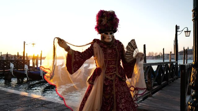 Venice, Italy - February 2022 - carnival masks are photographed with tourists in San Marco square