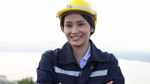Portrait of successful woman constructor wearing helmet Portrait of architect standing at outdoor and looking at camera.