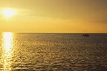 Picturesque seaside resort town in Slovenian coast against orange sunset sky in summer. Scenic view of Adriatic sea in the evening. Travel concept
