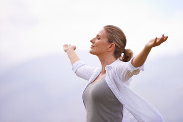 Feeling calm in nature. A woman doing yoga out.