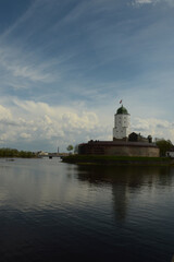 Fototapeta na wymiar medieval white castle in russia on the water against the background of clouds in cloudy weather free space