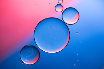 Composition of big and small  circles oil drops on water.