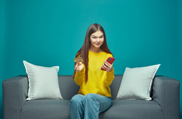 Modern girl use phone to make easy secure payments online in e-bank app, spending bonus cashback of...