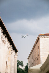 Airplane over the old buildings