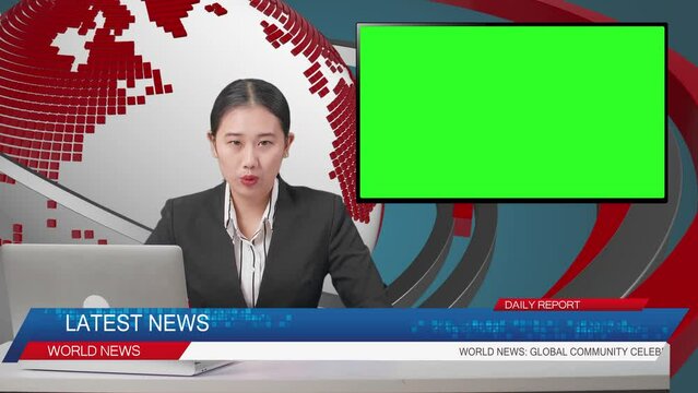 Live News Studio With Asian Professional Female Anchor, Computer, And Green Screen Television Reporting On The Events Of The Day
