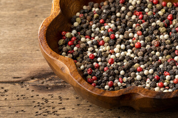 various types pepper spices on wooden table