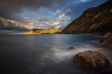 seascape and mountains at sunrise
