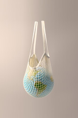 World globe in crochet bag, floating in air on beige background. Eco-friendly life in the style of...
