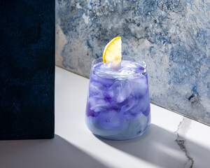 Anchan, butterfly cold drink. Cold blue tea with pieces of ice