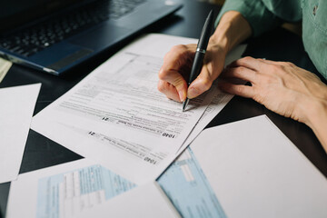 Woman filling US tax form 1040. tax form us business income office hand fill concept. Closeup