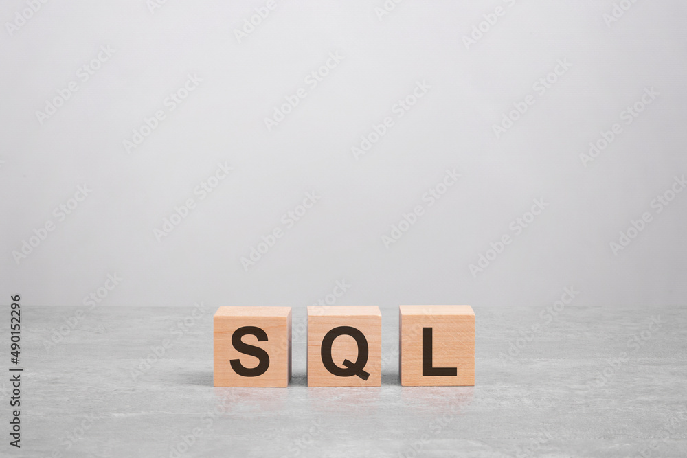 Poster business concept. wooden cube on a concrete surface with text sql