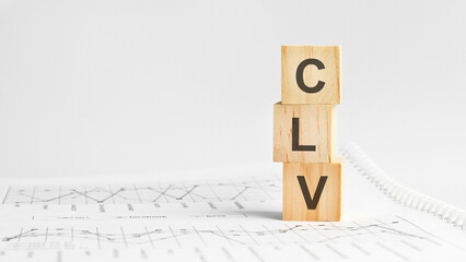 CLV - letters on wooden cubes. concept on cubes and diagrams on a gray background. business as usual concept imag.