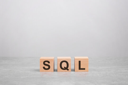 business concept. wooden cube on a concrete surface with text SQL