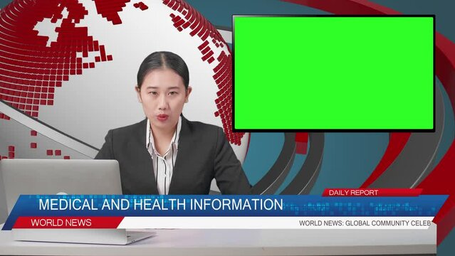Live News Studio With Asian Professional Female Anchor, Computer, And Green Screen Television Reporting On The Events Of The Day
