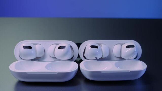 white wireless headphones and a white case
