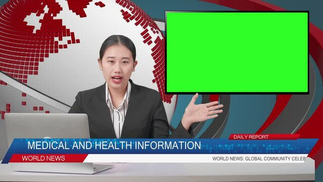 Live News Studio With Asian Professional Female Anchor, Computer, And Green Screen Television Pointing To Side While Reporting On The Events Of The Day
