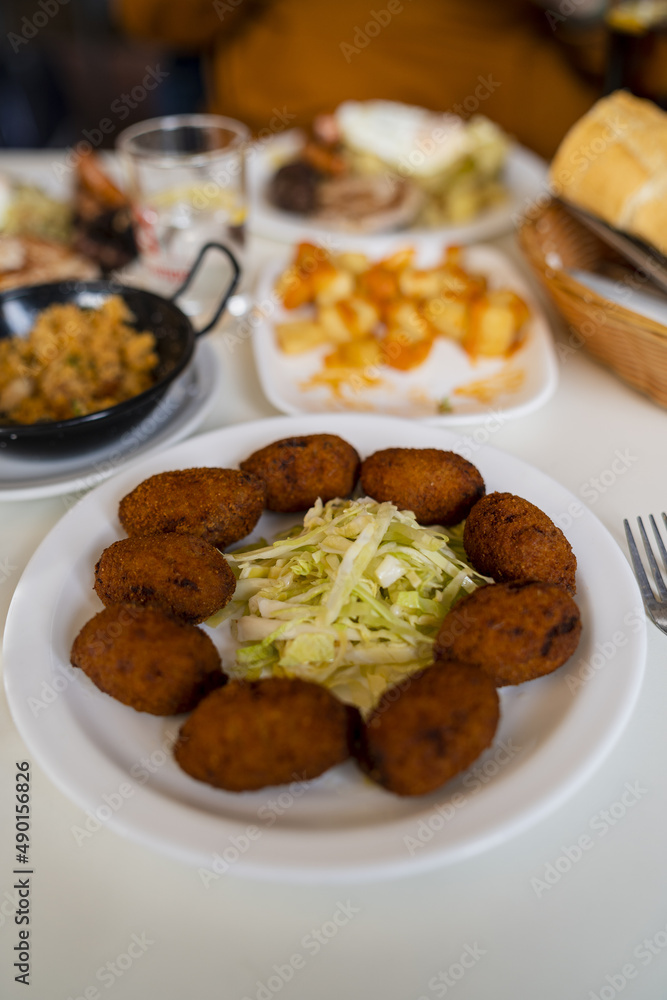 Canvas Prints selective focus shot of fritters with fresh cabbage served on a plate