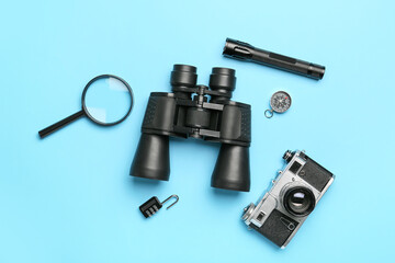 Set of travel items with photo camera on color background