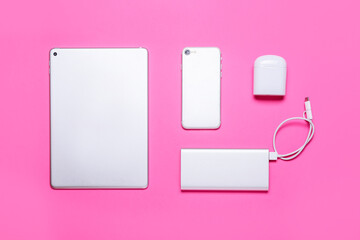 Set of modern gadgets on pink background