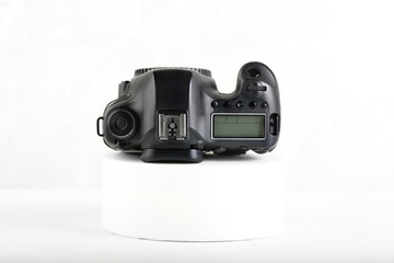 DSLR Digital Camera full frame sensor on white cement background.