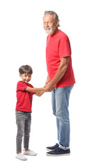 Little boy and his grandfather in red t-shirts on white background