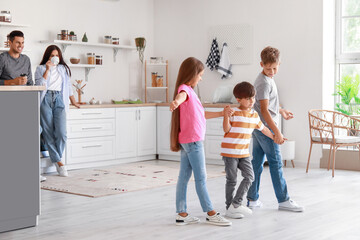 Fototapeta premium Happy family dancing in kitchen