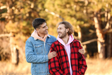 Happy gay couple outdoors on autumn day