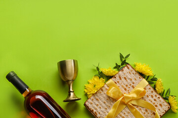 Jewish flatbread with goblet and bottle of wine on color background