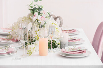 Stylish table setting with wedding invitations and gypsophila flowers