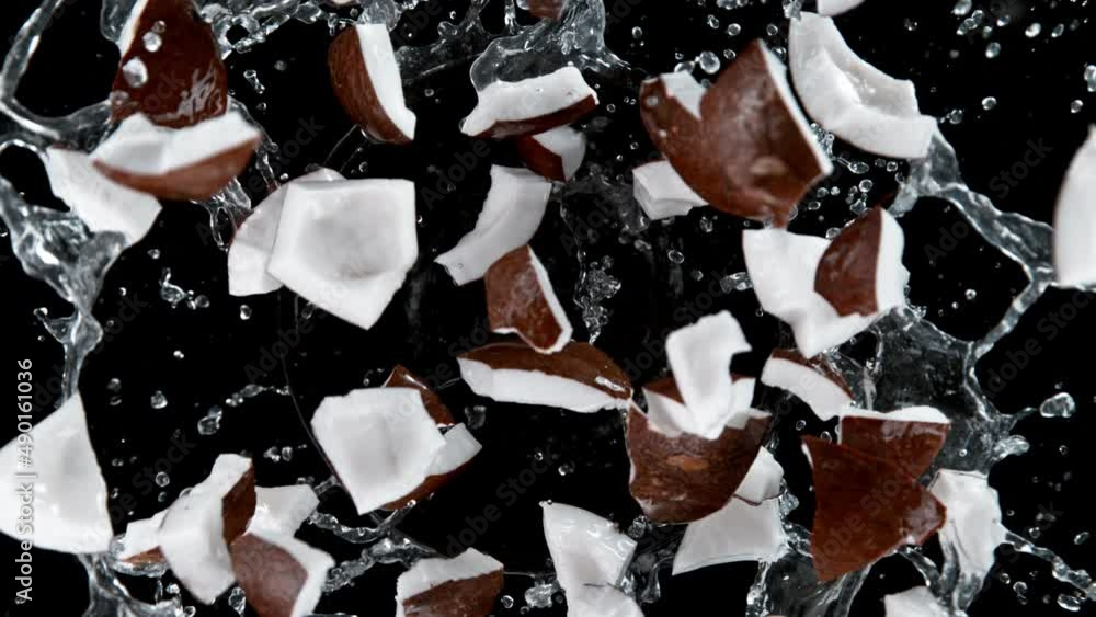 Aufkleber super slow motion of rotating coconut with splashing water, black background. filmed on high speed c