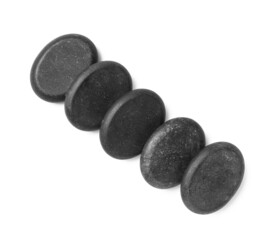 Group of black stones on white background, top view