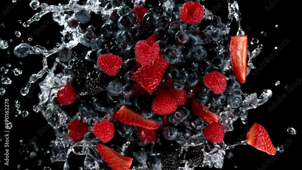 Poster Super slow motion of rotating berries fruit with splashing water, black background. Filmed on high speed cinema camera, 1000 fps.