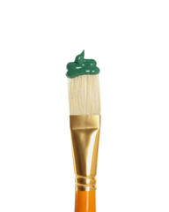 Brush with green paint on white background